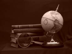 Globe with magnifying glass and books